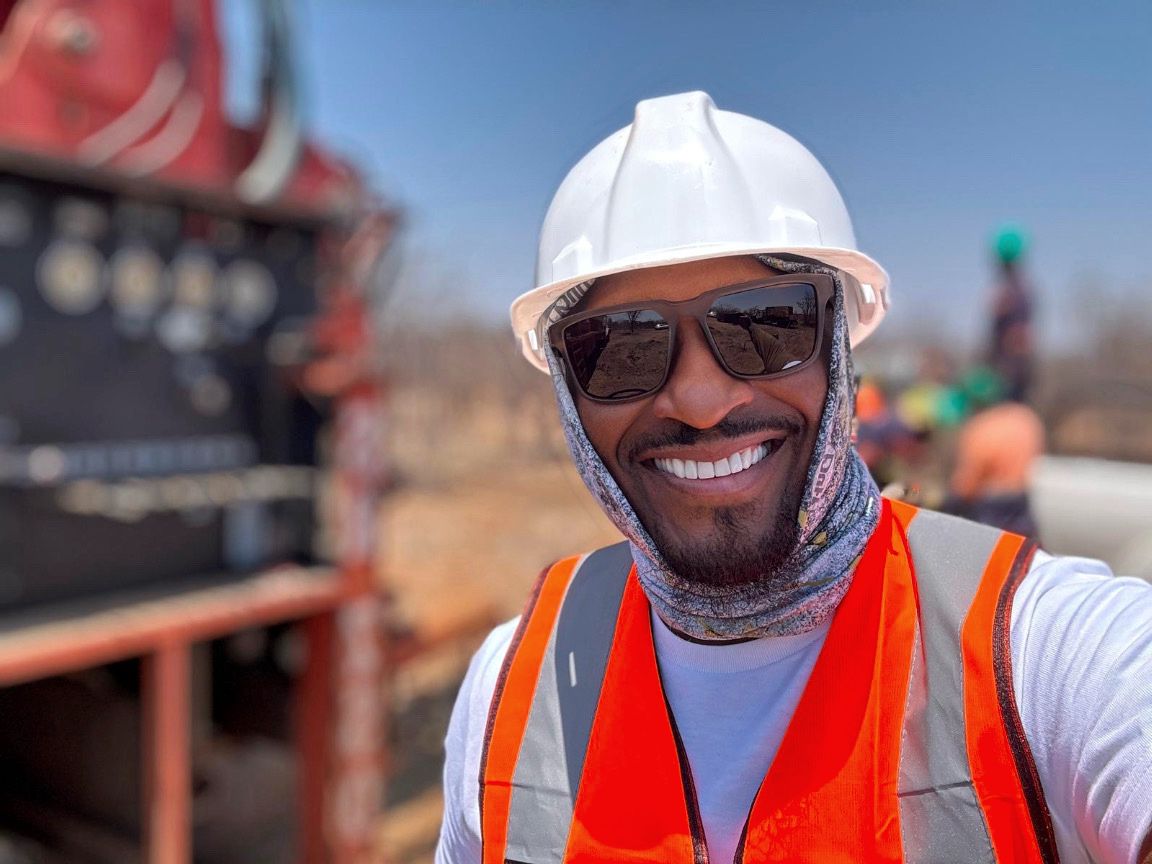 Musa Minerals field representative at the drill site in safety gear